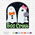 The Rustic Rhode DIY Boo Crew Arch Insert is a wooden Halloween sign with two smiling white ghosts—one with an orange bow tie, one with a pink hair bow and purple lollipop. Boo Crew appears in green below, along with paint color samples at the bottom.