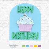 The Rustic Rhode DIY Happy Birthday Arch Insert features pastel cupcakes, colorful sprinkles, and green Happy Birthday text on a blue background—perfect for party décor. Paint color swatches appear below a scalloped arch frame on a white brick wall.