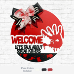 The Rustic Rhode’s DIY Let’s Talk About Serial Killers Door Hanger features “WELCOME, LET’S TALK ABOUT SERIAL KILLERS” with a red handprint, fake blood splatters, and a black, white, and red bow. Paint colors black, white, and red included.