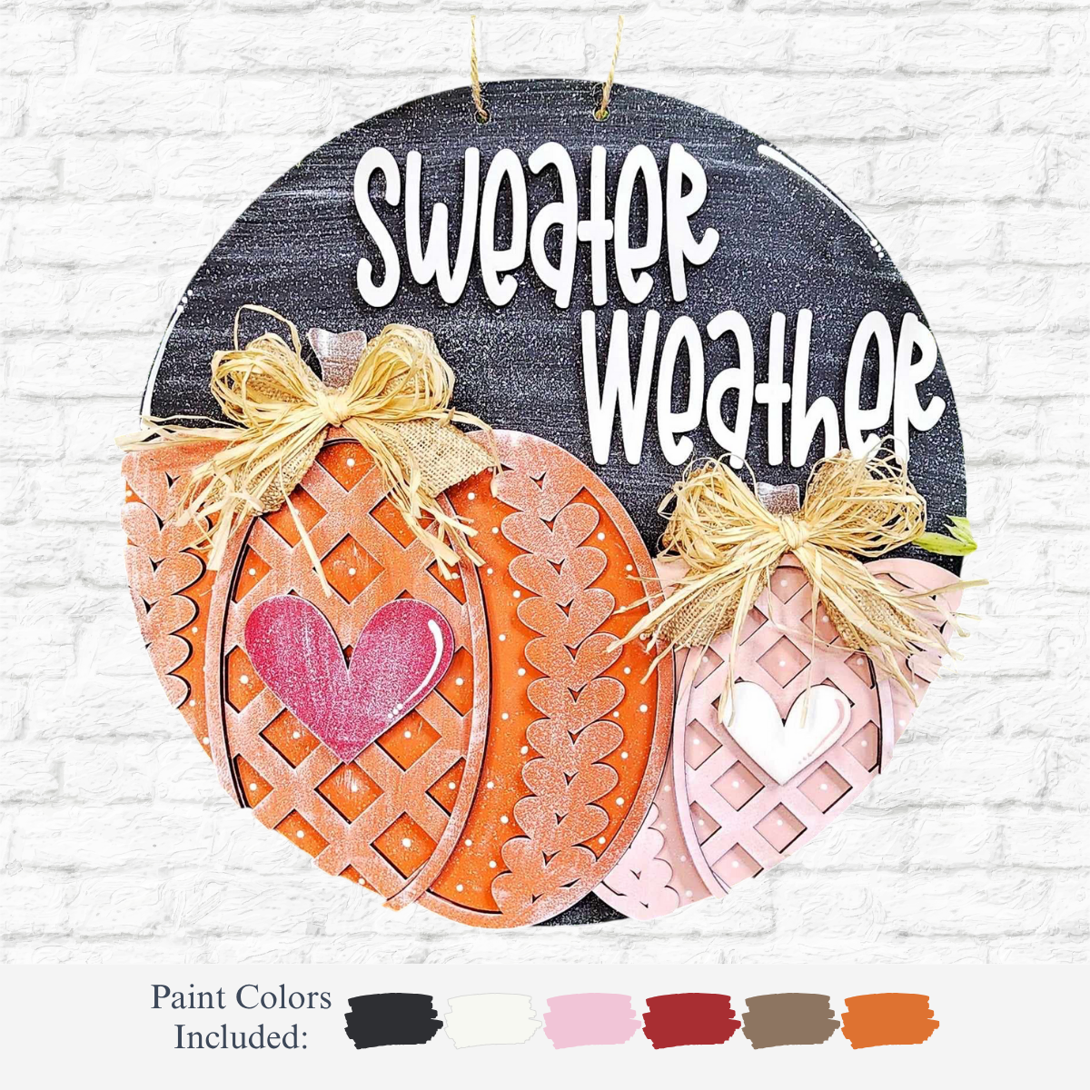 The Rustic Rhodes DIY Sweater Weather Door Hanger features a round sign with Sweater Weather in white, two decorated pumpkins, bows, hearts, and paint swatches—ideal autumn door decor.