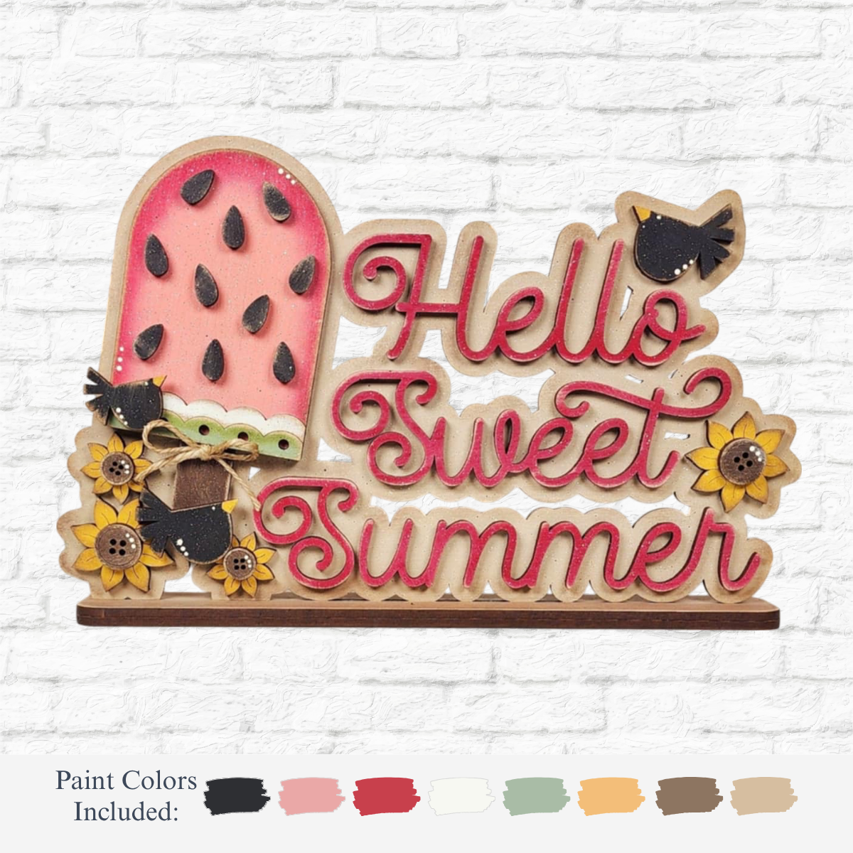 The Rustic Rhodes DIY Watermelon Word Block features a wooden sign with a pink watermelon slice, sunflowers, and two black birds. It reads Hello Sweet Summer in red. Ideal as seasonal home decor or a summer craft kit with paint color options available.