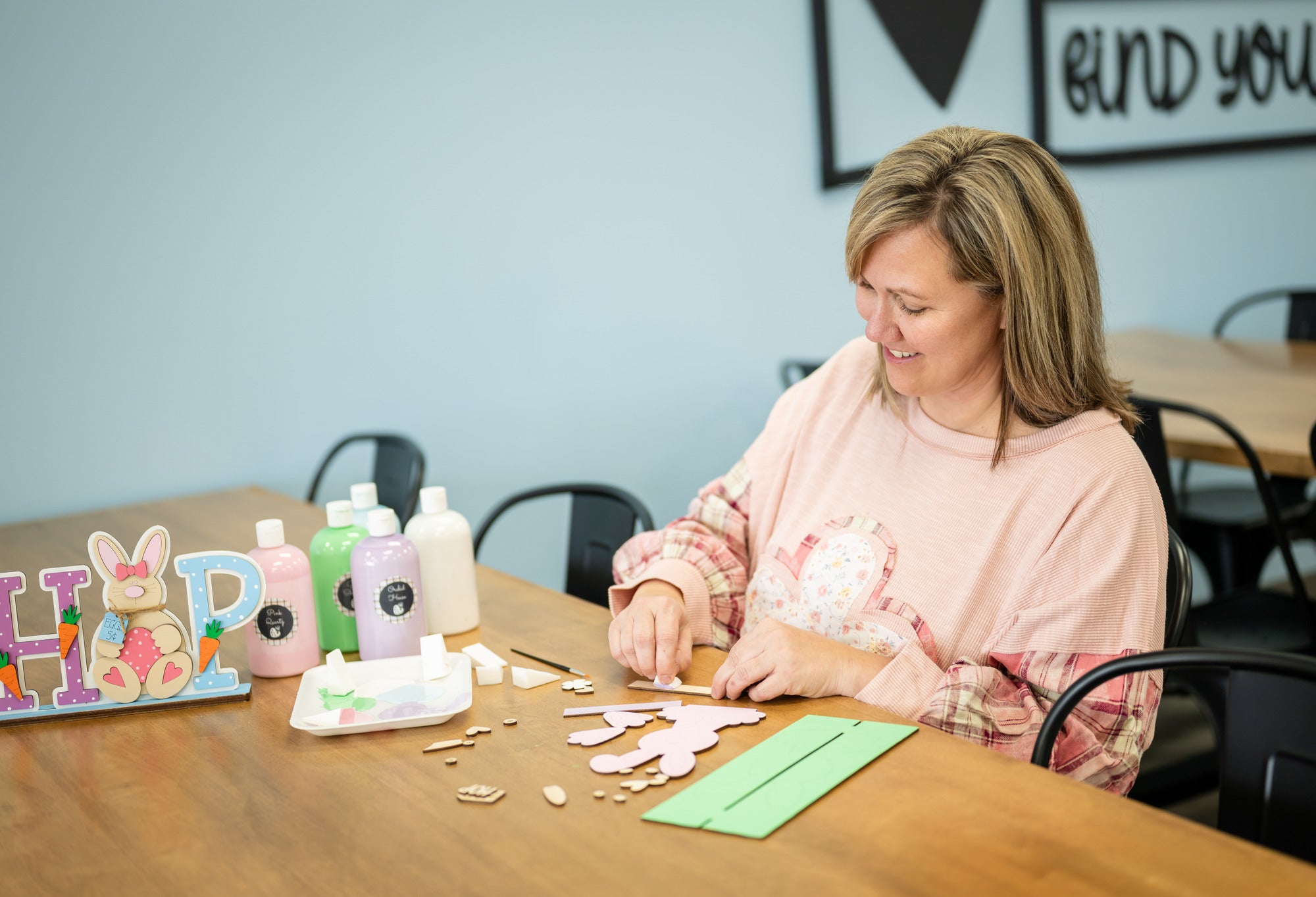 Rustic Rhode founder sitting at her Rhode Island craft studio and making a craft