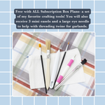 A set of crafting tools—paintbrushes, a craft knife, an eye needle, and two mini easels—are arranged on white pouches atop a plaid surface. Get these free with all DIY Tiered Tray Subscription Box plans from The Rustic Rhode.