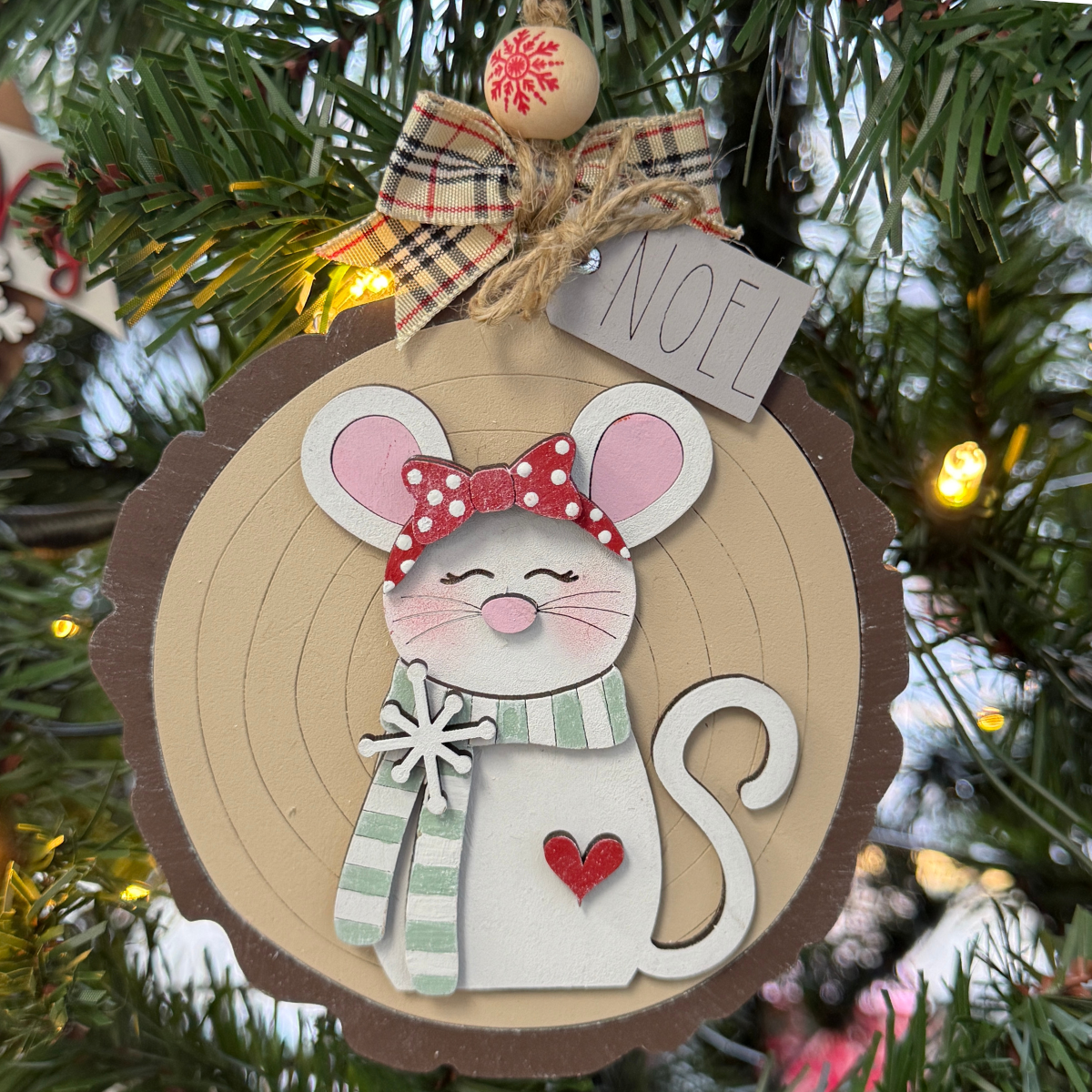 The Rustic Rhode DIY Woodland Creatures Ornament—Mouse w/ Scarf features a cute mouse with red polka-dot bow, green scarf, heart detail, plaid bow, NOEL tag, and includes unassembled pieces for creative holiday fun.