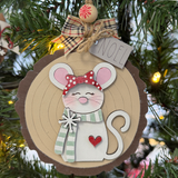 The Rustic Rhode DIY Woodland Creatures Ornament—Mouse w/ Scarf features a cute mouse with red polka-dot bow, green scarf, heart detail, plaid bow, NOEL tag, and includes unassembled pieces for creative holiday fun.