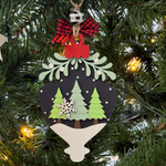 The Rustic Rhode’s DIY Mistletoe Ornament- Christmas Tree features a bauble with green trees, white snowflake, and snow on black. Perfect for ornament kits or painting your own. Includes red bow and plaid bead for finishing.