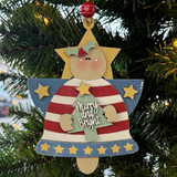 The Rustic Rhode’s DIY Christmas Angel Ornament–Merry & Bright features an angel with a striped dress, holly crown, yellow stars, and a green tree. Unassembled pieces make it perfect for painting before adding to your festive decor.