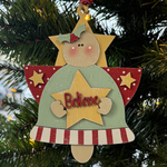 The Rustic Rhode’s DIY Christmas Angel Ornament- Believe kit includes all you need to paint a wooden angel with rosy cheeks, holly, and a star—perfect for personalizing and hanging on your Christmas tree.