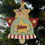 The Rustic Rhode’s DIY Christmas Angel Ornament- Believe kit includes all you need to paint a wooden angel with rosy cheeks, holly, and a star—perfect for personalizing and hanging on your Christmas tree.