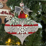 The Rustic Rhode's DIY Mistletoe Ornament—Snowflakes features a gray and red design with white snowflakes, green leaves, and a checkered bow, perfect for painting at home or gifting as an unassembled ornament kit. Warm lights add festive cheer.