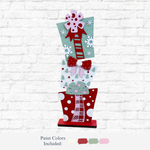 The Rustic Rhode DIY 32 Inch Stacked Presents features three painted wooden gift boxes with bows, polka dots, and snowflakes in red, white, and pale green—ideal for festive holiday decor or as oversized stacked presents.