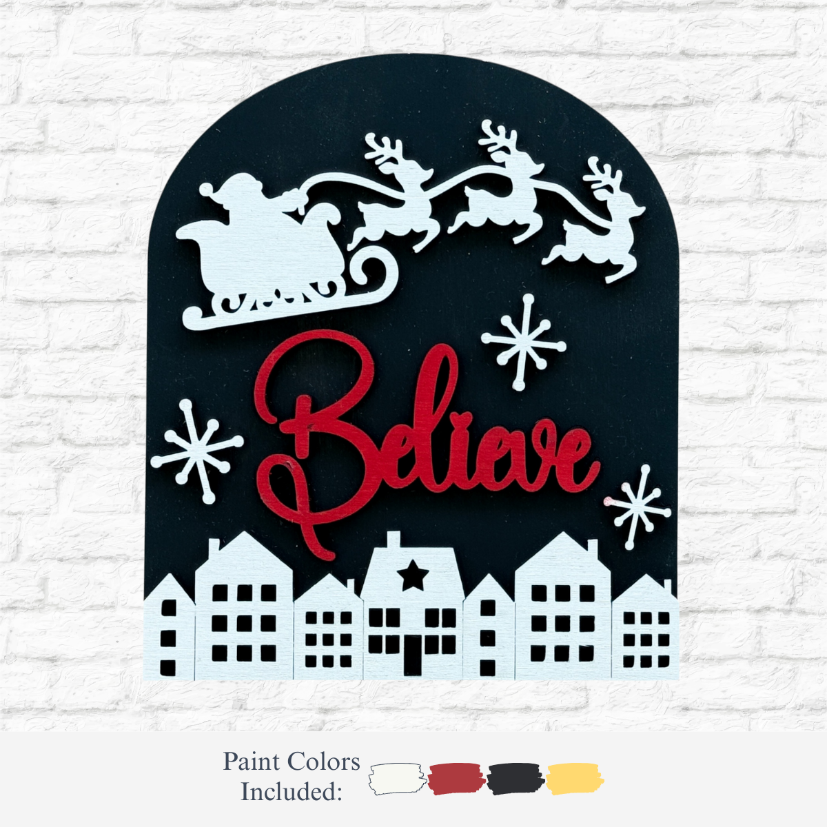 The Rustic Rhode’s DIY Believe In Santa Arch Insert features a white Santa sleigh and reindeer over red “Believe” script, with snowy houses below. Designed for Scalloped Arch Frames; paint colors included: white, black, red, yellow.