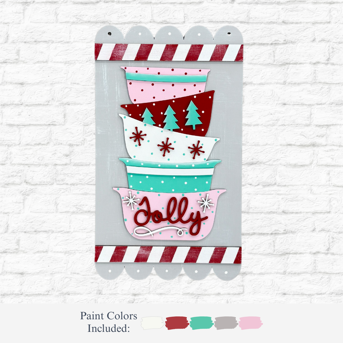 The Rustic Rhode’s DIY Christmas Baking Hanging Sign features three stacked bowls with festive designs and “Jolly” on the red base, framed by a candy cane striped border—perfect holiday décor for your wall.