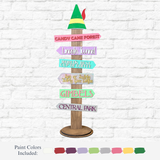 The Rustic Rhode’s DIY Elf Movie Directional Signpost, topped with a green elf hat, features colorful arrows to Candy Cane Forest and more—perfect as Elf movie décor or a festive holiday craft kit.