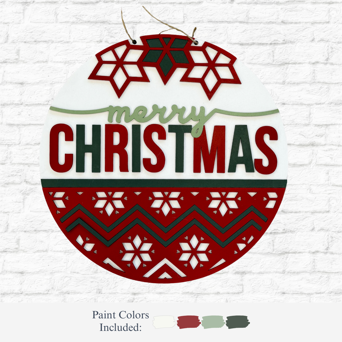 The Rustic Rhode's DIY Fair Isle Merry Christmas Door Hanger features red and green "merry CHRISTMAS" text, snowflakes, zigzags, and comes with red, olive green, and white paints—perfect for festive door or holiday décor.