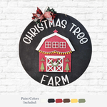 The Rustic Rhode's DIY Farmhouse Christmas Door Hanger features a round black sign with "Christmas Tree Farm" in white, a red barn with garland and wreath, topped with a red plaid bow. Paint colors included. Perfect rustic holiday decor!.