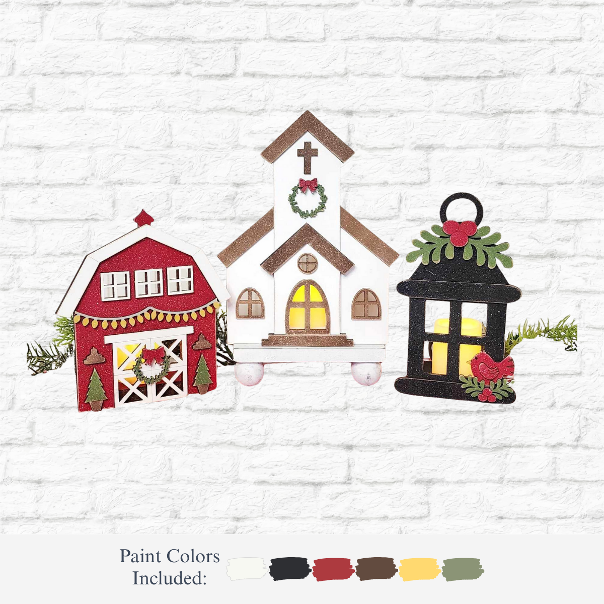 The Rustic Rhode DIY Farmhouse Christmas House Votive Set features three holiday wood decorations—a red barn, white church, and black lantern with red bird—displayed against a white brick wall, with included paint colors shown below.