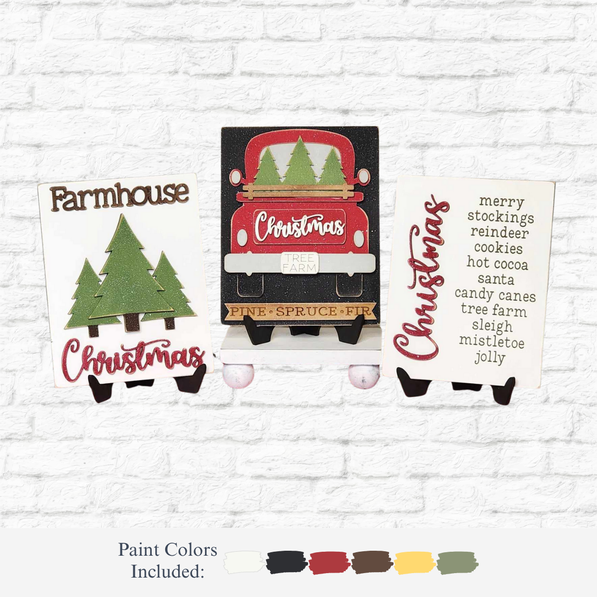The Rustic Rhode’s DIY Farmhouse Christmas Trio Sign set features three wood signs with trees, a red truck, and festive words against a white brick background. Paint color samples in white, green, black, red, yellow, and brown are shown below.