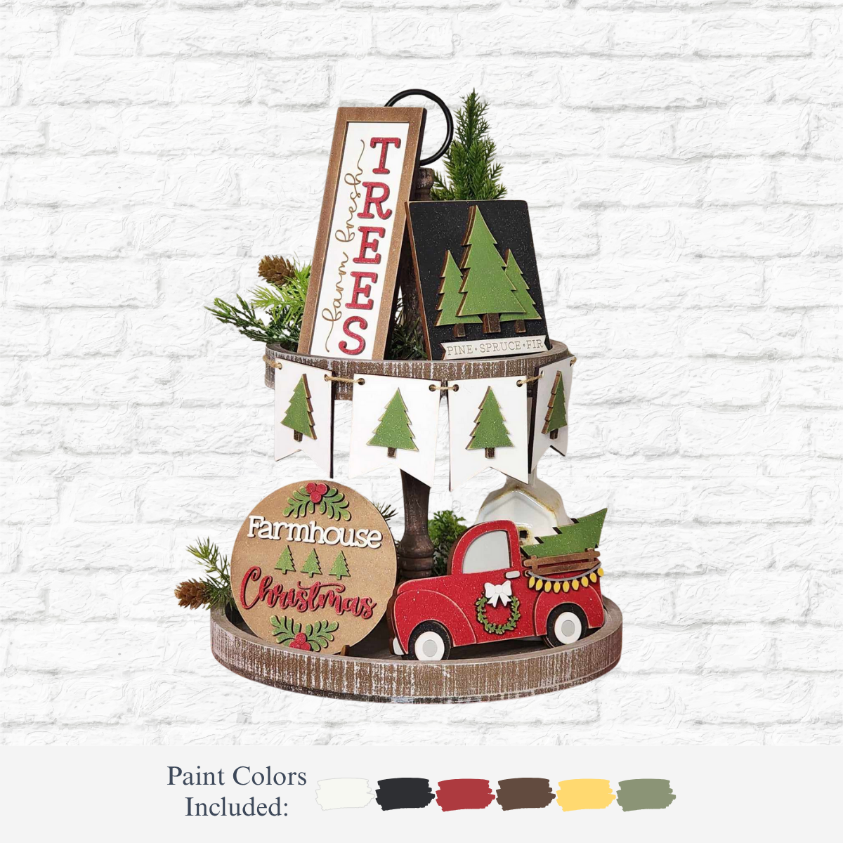The Rustic Rhode DIY Farmhouse Christmas Tiered Tray Kit includes a two-tiered wooden tray, Christmas signs, a red truck with tree, mini trees, garland, and paint in white, black, green, red, yellow, and brown—perfect for holiday décor.