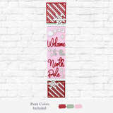 The Rustic Rhode's DIY North Pole Porch Leaner features “Welcome to the North Pole” text, Santa’s sleigh, and festive colors—perfect Christmas porch decor for your white brick wall.