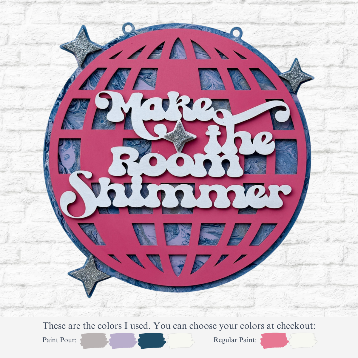A pink disco ball sign, “Make the Room Shimmer” in white with stars, hangs on a white brick wall. DIY Paint Pour-Mirrorball by The Rustic Rhode—great for Taylor Swift crafts. Paint color options shown below the image.