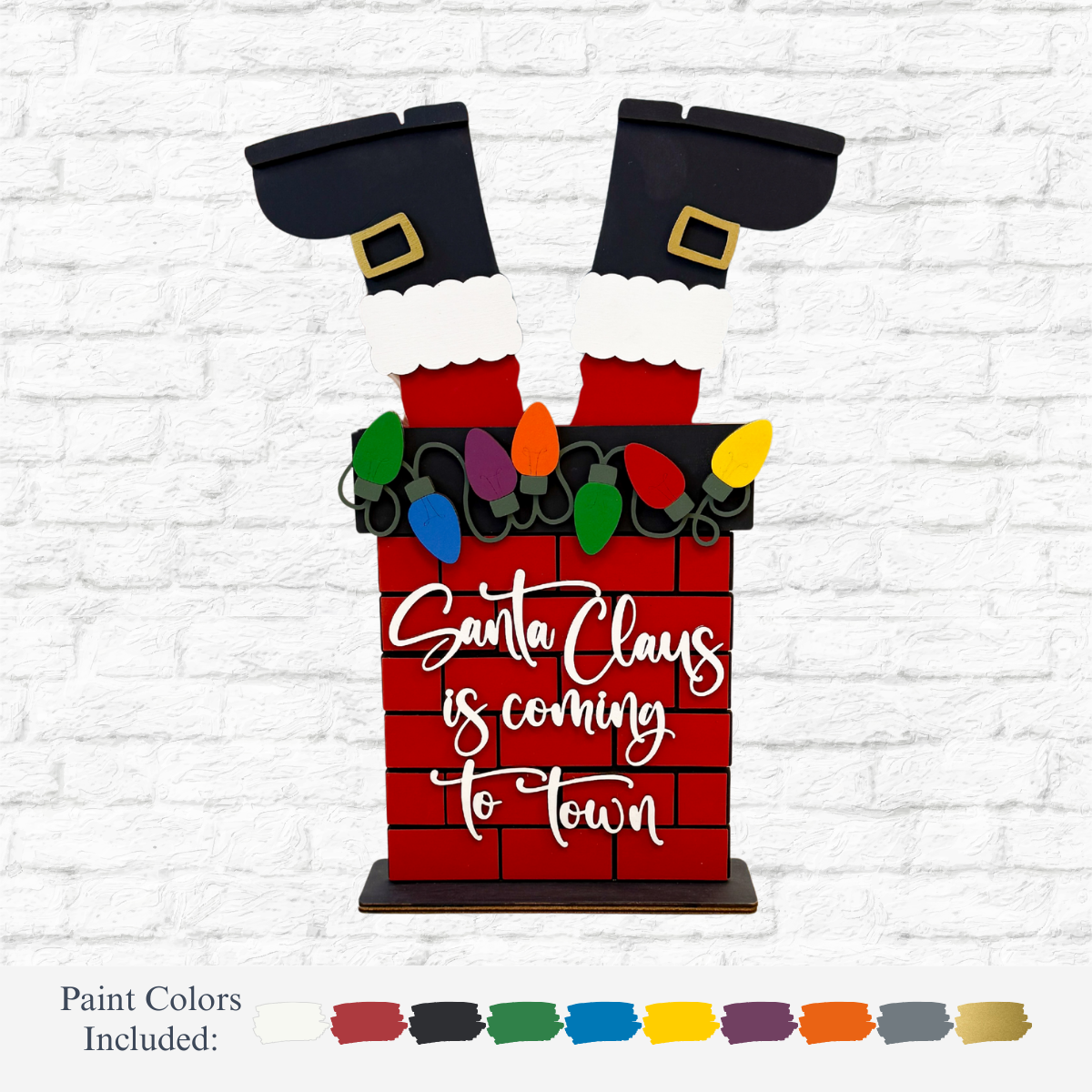 The Rustic Rhode’s DIY Santa Chimney kit features Santa’s legs in a red brick chimney with colorful lights and “Santa Claus is coming to town” on the front. Paint colors are displayed below.