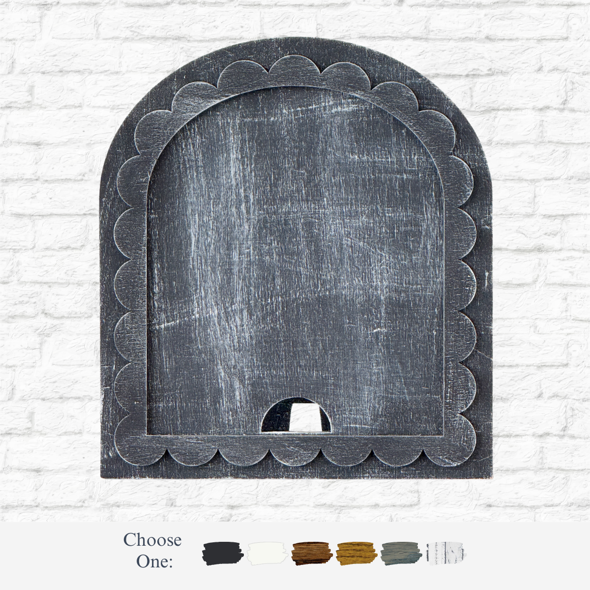The Rustic Rhode’s DIY Scalloped Arch Insert Frame in black stands against a white brick wall, with six neutral paint swatches below and the text Choose One: displayed.