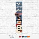 The Rustic Rhode’s DIY Snowman Porch Leaner features “Baby it’s Cold Outside” in white, a snowman, striped bow, and painted gift—perfect holiday décor with five shown paint colors.