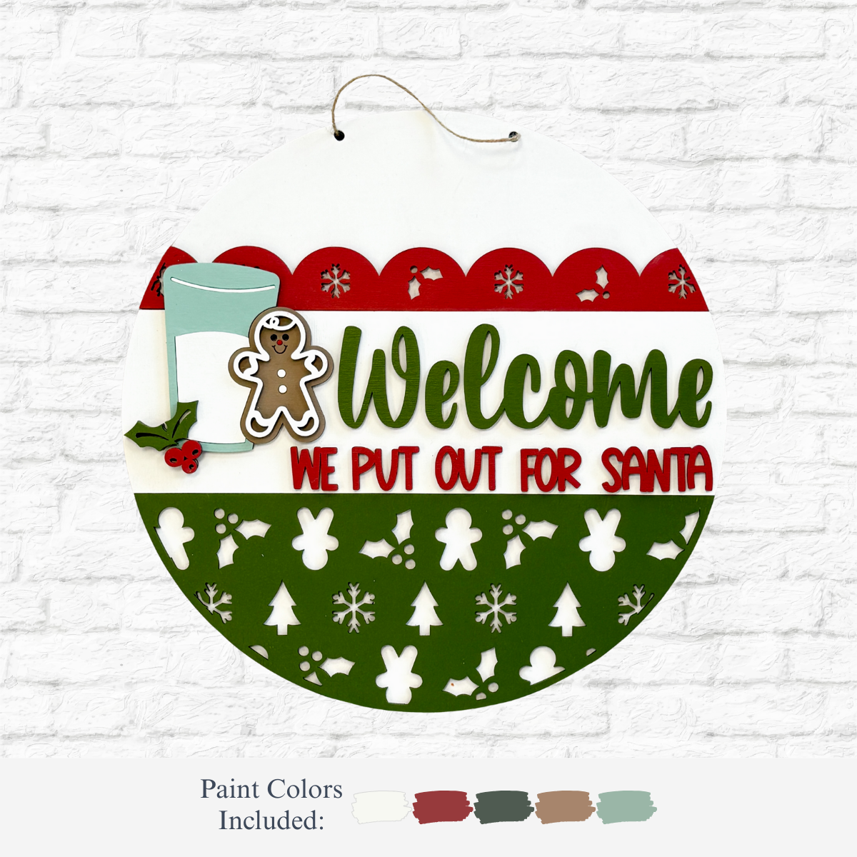 The Rustic Rhode DIY We Put Out For Santa Door Hanger features green and red lettering, festive cookie and milk designs, holly, holiday patterns on a white brick background, plus five paint swatches—ideal for Christmas décor or a unique DIY project.