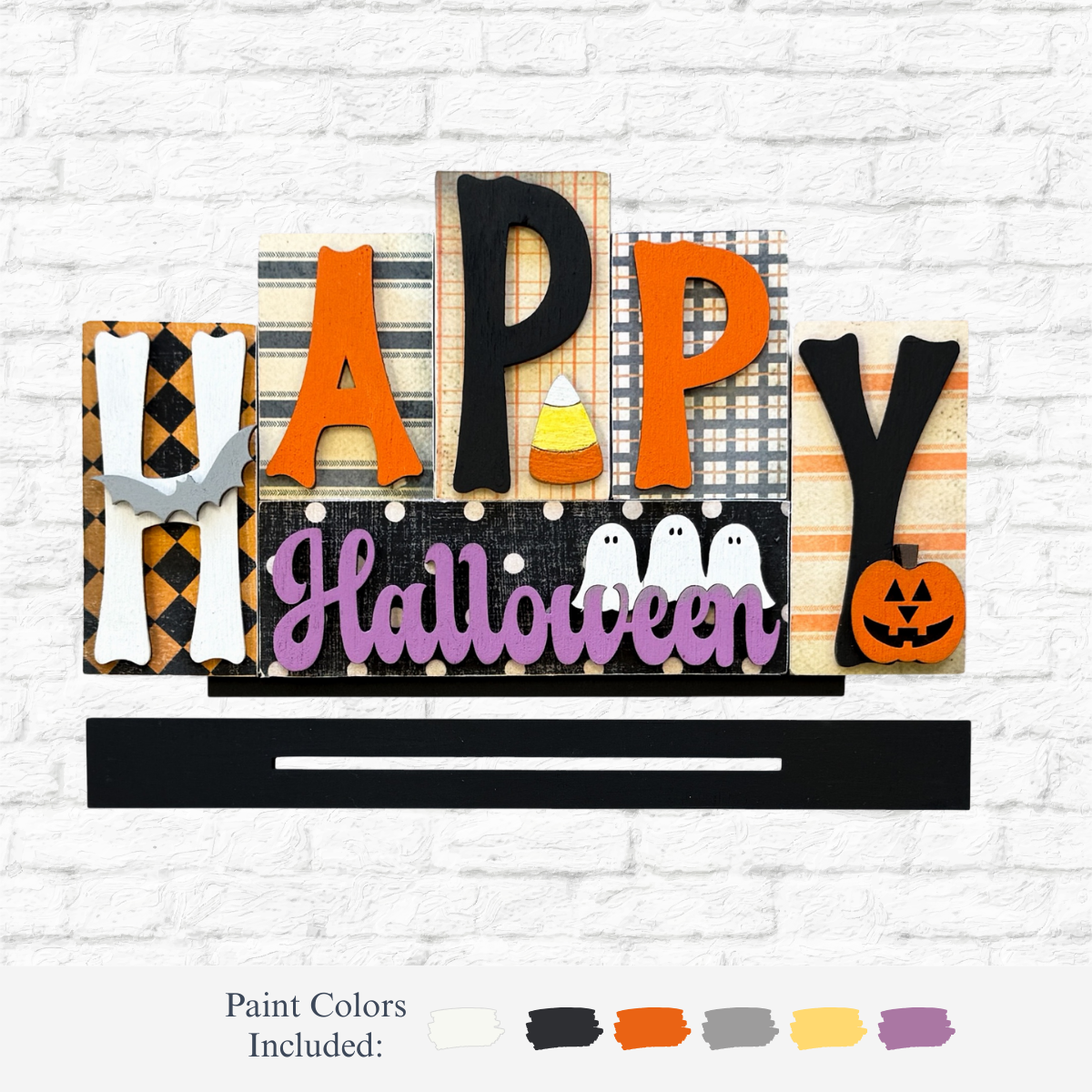 The Rustic Rhodes DIY Happy Halloween Word Block features bones, candy corn, ghosts, and a jack-o-lantern. With white, black, orange, yellow, gray, and lavender paint accents, its perfect for festive Halloween décor.