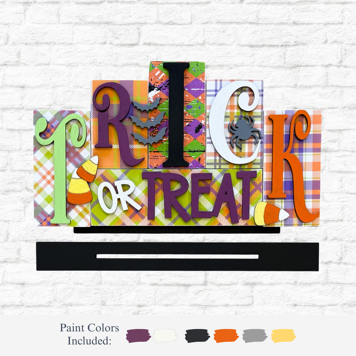 The Rustic Rhode DIY Trick or Treat Word Block features playful, patterned letters and Halloween icons like candy corn and a spider. Display against any wall; includes six paint swatches for a custom festive look—perfect for your seasonal décor!.