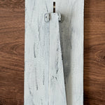 The Rustic Rhode DIY Interchangeable Farmhouse Frame is a distressed white wood piece with a triangular stand, resting on brown wood—ideal for personalized home decor.