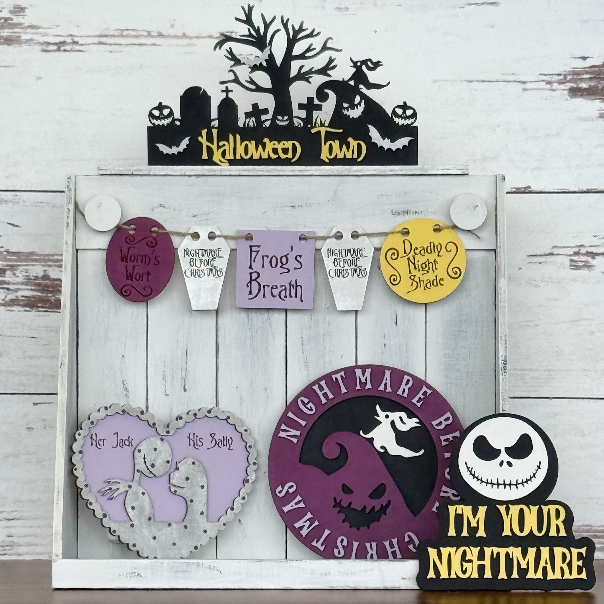 Discover "This is Halloween...Craft Night!" by The Rustic Rhode—a display of wooden decorations with Halloween Town, Frog’s Breath, and Im Your Nightmare signs in black, purple, and yellow. Ideal for Halloween crafting fans.