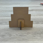 The Rustic Rhode DIY North Pole Santa Word Stacker is a stepped brown wooden decor piece with a small base and support stick—ideal for your next holiday craft kit project.