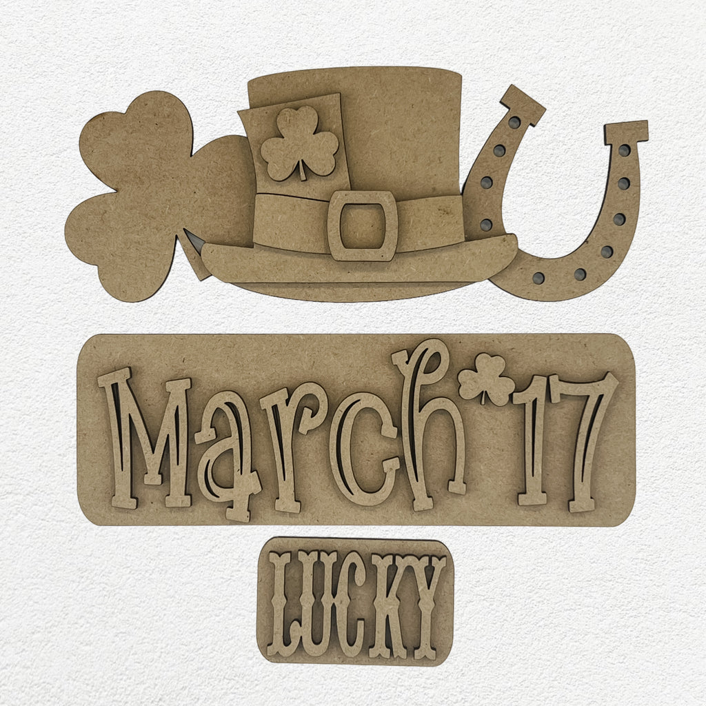 A sign displaying a hat, horseshoe, and shamrock, representing St. Patrick's Day DIY Kits for Interchangeables.