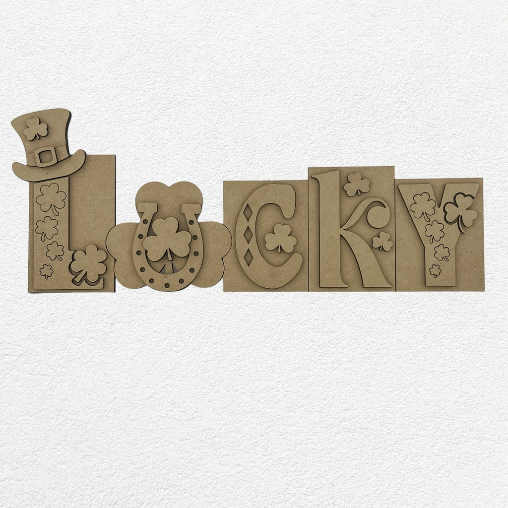 DIY St. Patrick's Day wooden letters spelling out 'Lucky' on a wooden surface